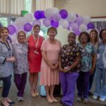 Christopher Carter, Ann Pavano, and the staff of McLean Life Plan Community pose for the community's Purple Flag reaccreditation.